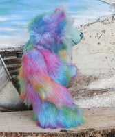 Syracuse standing, viewed from the side, showing his profile.
Syracuse is a large and beautifully coloured one of a kind artist bear by Barbara Ann Bears in luxurious multi-coloured fluffy faux fur and very long, turquoise mohair he stands 19 inches/48 cm tall