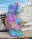 Syracuse standing, viewed from the side, showing his profile.
Syracuse is a large and beautifully coloured one of a kind artist bear by Barbara Ann Bears in luxurious multi-coloured fluffy faux fur and very long, turquoise mohair he stands 19 inches/48 cm tall