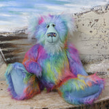 Syracuse sitting.
Syracuse is a large and beautifully coloured one of a kind artist bear by Barbara Ann Bears in luxurious multi-coloured fluffy faux fur and very long, turquoise mohair he stands 19 inches/48 cm tall