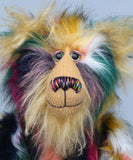 Syracuse's face showing his fluffy blonde beard, his hand painted glass eyes, multi coloured nose and sweet smile. Syracuse is a 19 inch one of a kind, artist bear by Barbara-Ann Bears in luxurious blonde mohair and beautifully colourful faux fur