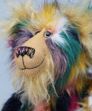 Syracuse's face showing his fluffy blonde beard, his hand painted glass eyes, multi coloured nose and sweet smile. Syracuse is a 19 inch one of a kind, artist bear by Barbara-Ann Bears in luxurious blonde mohair and beautifully colourful faux fur
