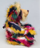 Syracuse sitting in profile, Syracuse is a 19 inch one of a kind, artist bear by Barbara-Ann Bears in luxurious blonde mohair and beautifully colourful faux fur
