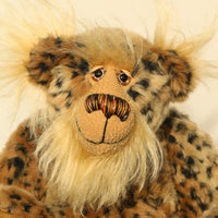 Tarzan McKenzie's face. He is a very fashionable and exotic, one of a kind, artist bear by Barbara-Ann Bears in leopard print faux fur and fluffy gold mohair. He has ochre felt paw pads, hand painted glass eyes, a beautifully embroidered nose and a huge smile.