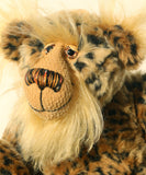 Tarzan McKenzie's face. He is a very fashionable and exotic, one of a kind, artist bear by Barbara-Ann Bears in leopard print faux fur and fluffy gold mohair. He has ochre felt paw pads, hand painted glass eyes, a beautifully embroidered nose and a huge smile.