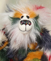 Tommy Truckle is a gentle and loving one of a kind, artist bear by Barbara-Ann Bears in luxurious mohair and beautifully colourful faux fur, he stands 11 inches/28 cm tall.  Tommy is made from faux fur in green, yellow ochre, red, cream and black, with a luxurious, long white fluffy mohair and hand dyed velvet paw pads