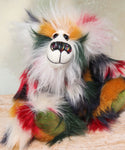 Tommy Truckle is a gentle and loving one of a kind, artist bear by Barbara-Ann Bears in luxurious mohair and beautifully colourful faux fur, he stands 11 inches/28 cm tall.  Tommy is made from faux fur in green, yellow ochre, red, cream and black, with a luxurious, long white fluffy mohair and hand dyed velvet paw pads