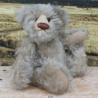 Wolfie sitting.
Wolfie is a wild and groovy guy, a veteran artist bear from Barbara-Ann Bears in silvery grey English mohair, he stands 10 inches/25 cm tall. 