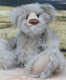 Wolfie sitting.
Wolfie is a wild and groovy guy, a veteran artist bear from Barbara-Ann Bears in silvery grey English mohair, he stands 10 inches/25 cm tall. 