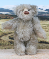 Wolfie standing.
Wolfie is a wild and groovy guy, a veteran artist bear from Barbara-Ann Bears in silvery grey English mohair, he stands 10 inches/25 cm tall. 