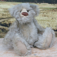 Wolfie sitting.
Wolfie is a wild and groovy guy, a veteran artist bear from Barbara-Ann Bears in silvery grey English mohair, he stands 10 inches/25 cm tall. 