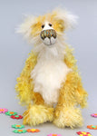 Alfredo Buttercup, a comical yet elegant yellow and white, one of a kind artist teddy bear in stunning hand dyed mohair by Barbara-Ann Bears. Alfredo Buttercup stands 17 inches (43 cm) tall and is 13 inches (33 cm) sitting. He is mostly made from a long and straggly mohair hand-dyed in sunny shades of yellow and gold.