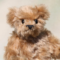 Angus is a very sweet and friendly artist teddy bear in gorgeous mohair by Barbara Ann Bears, he is 7.5 inches/19 cm tall and is 6 inches/15 cm sitting.  Angus is a wonderful traditional teddy bear, a bear we made in the early 1990s, he is made from a grey mohair that has very fine black threads running through it.  Angus has grey wool felt paw pads and gorgeous vintage boot buttons for eyes, he has a little, carefully embroidered black nose and a very relaxed and lovable expression. 