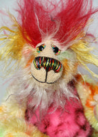 Basil is made from a short, straight mohair hand dyed in yellow, green, lime, orange, red and blue. His tummy is pink faux fur with black rosettes, his face is a long white mohair with blue tips, the top of his head is a long red mohair and the fronts of his ears and the underside of his tail are a long mohair hand dyed bright yellow. Basil has hand dyed velvet paw pads. Basil has hand painted eyes with eyelids, a splendid nose embroidered from individual coloured threads and he has a huge smile