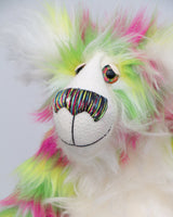 Bedivere has very large, beautifully hand painted glass eyes with hand painted eyelids and a wonderfully embroidered nose, sewn from individual threads to match his colouring. He has a thoughtful expression and a huge beaming smile. He is made from the most gorgeous and luxurious long faux fur with tiger-like overlaying bands of the brightest magenta, grass green and lemony yellow. His face, tummy, the fronts of his ears and the underside of his tail are a very, long and fluffy white mohair