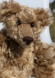 Bernard McFluff is made from a beautiful, distressed, shaggy, soft brown English mohair. He has black Austrian glass, spherical eyes, these catch the light from any angle so he always has a cheeky twinkle in his eye. Bernard McFluff has a neatly sewn nose and a sweet smile. 