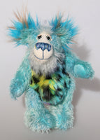 Billy Calypso is a gentle, happy teddy bear, a beautifully blue one of a kind, hand-dyed mohair artist bear by Barbara-Ann Bears Billy Calypso stands 9 inches/23 cm tall and is 6.5 inches/16 cm sitting. He is mainly made from a fluffy, sparse mohair that Barbara has hand dyed a beautiful sky blue