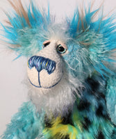 Billy Calypso has beautiful hand painted eyes with eyelids, a nose embroidered from individual threads to complement his colouring and he has a huge, friendly smile. Billy's face is a long and fluffy white mohair with blue tipping. On top of Billy's head and on the backs of his ears is a very long aqua faux fur with tufts of warm beige.