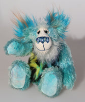 Billy Calypso is a gentle, happy teddy bear, a beautifully blue one of a kind, hand-dyed mohair artist bear by Barbara-Ann Bears Billy Calypso stands 9 inches/23 cm tall and is 6.5 inches/16 cm sitting. He is mainly made from a fluffy, sparse mohair that Barbara has hand dyed a beautiful sky blue