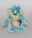 Bim-Bam is made from several different mohairs, he's mainly a medium length, slightly distressed and sparse mohair hand dyed a beautiful aqua, his tummy is a slightly longer, dense mohair hand dyed in silver, with hints of blue and purple, his back is shorter, sparse mohair dyed sky blue and his face, the fronts of his ears and the underside of his tail are a longer, fluffy mohair hand-dyed a light, happy yellow. The top of his head is a plume of aqua faux fur. Bim-Bam has hand dyed velvet paw pads