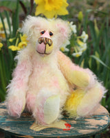 Blossom is a sweet and gently colourful, one of a kind mohair artist bear by Barbara-Ann Bears, she stands 10 inches/25 cm tall and is 8 inches/20 cm sitting. Blossom is made from medium length wildly curly mohair that Barbara has hand dyed a soft primrose yellow and delicate pink with matching hand dyed velvet paw pads