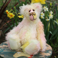 Blossom is a sweet and gently colourful, one of a kind mohair artist bear by Barbara-Ann Bears, she stands 10 inches/25 cm tall and is 8 inches/20 cm sitting. Blossom is made from medium length wildly curly mohair that Barbara has hand dyed a soft primrose yellow and delicate pink with matching hand dyed velvet paw pads