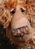Boris has beautiful hand painted slightly sparkling glass eyes (they were painted to match his mohair) with hand-coloured eyelids, an impressive and wonderfully embroidered nose, sewn from individual threads to match his mohair and an engaging smile.