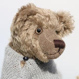Bosworth is a solid and distinguished one of a kind, traditional, mohair artist teddy bear by Barbara Ann Bears, he stands 17 inches (43cm) tall and is 12 inches (31cm) sitting and made from fairly long, slightly wavy greyish-brown brown mohair with a hint of green, he has beige wool felt paw pads and hand painted eyes and wears a hand knitted jumper