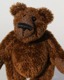 Bruce McCubbin is a very sweet and happy little brown mohair artist bear by Barbara Ann Bears, he stands just 6 inches( 15 cm) tall and is 4.5 inches (11 cm) sitting. Bruce McCubbin is made from a short, stubbly brown mohair, perfect mohair for a proper little bear, his paw pads are made from the same mohair trimmed