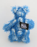Charlie McCubbin is a very sweet and happy little blue mohair artist bear by Barbara Ann Bears, he stands just 5.5 inches( 14 cm) tall and is 4 inches (10 cm) sitting. Charlie McCubbin is made from a sparse, stringy blue mohair that has a pale, almost white, cotton backcloth, giving him a charmingly scruffy appearance