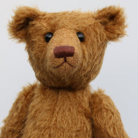Cinnamon has boot buttons for eyes, just like the really old teddy bears. He has a carefully embroidered nose and a sweet smile
