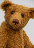  Cinnamon is the first of his design . He was designed to be proportioned like the very earliest teddy bears, with longer arms, a long snout and to be quite bear-like, not too cute but still very lovable.