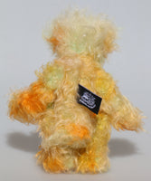 Daffy Doolittle is a very happy and colourful one of a kind, hand dyed mohair and faux fur artist bear by Barbara-Ann Bears, she is 8.5 inches/21 cm tall. Daffy Doolittle is mostly a very curly and fairly mohair that Barbara has hand dyed in beautiful shades of yellow, green, lime and orange, with colourful faux fur. 