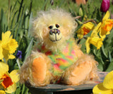 Daffy Doolittle is exceedingly cheerful and wonderfully colourful. Daffy is a bear who loves explore the garden, she heads out as soon as it's warm and dry enough, and not too windy. Suitable conditions for an expedition into the garden usually arise at about the same time as the daffodils are blooming, we think of her as a daffodil bear, hence her name, she really loves daffodils too, unfortunately she does very little to help in the garden, hence the second part of her name. 