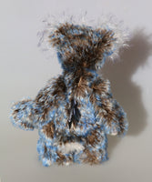 Danny Dalrymple's main mohair is a medium length, slightly wavy German mohair that has a dark brown base, the tips were then bleached and then the very ends dyed blue, so it has three colours along each thread. His tummy is a dense straight pile nearly white mohair which has a few black threads and his face, the fronts of his ears and the underside of his tail are a long fluffy white mohair tipped with blue. He has hand-dyed velvet paw pads which tie in with his mohair beautifully.