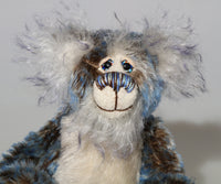 Danny Dalrymple has beautiful, hand painted eyes with eyelids, a splendid nose embroidered from individual threads to complement his colouring and he has a sweet, friendly smile. His main mohair is a slightly wavy German mohair that has a dark brown base, the tips were then bleached and then the very ends dyed blue and his face, the fronts of his ears and the underside of his tail are a long fluffy white mohair tipped with blue