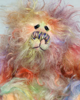 Dear Prudence, a bright and friendly, one of a kind, artist teddy bear by Barbara-Ann Bears, she stands 8.5 inches( 21 cm) tall and is 6.5 inches ( 16 cm) sitting.  Dear Prudence is made from a very long and twirly mohair that Barbara has dyed in oranges, greens, blues, reds, yellows, maroons, purples and lilacs