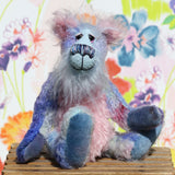 Delilah Dingles is mostly made from a medium length, sparse, quite straight mohair that Barbara has dyed in several gentle shades of blue with small splashes of pink, violet and green. Her tummy, the fronts of her ears and the underside of her tail are a longer, distressed soft pink mohair and her face is a very long, soft and wispy pale blue mohair. Delilah's hand dyed velvet paw pads coordinate very well with her main colours.