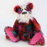 Delphine is a beautifully coloured, one of a kind, artist bear by Barbara-Ann Bears in luxuriously fluffy mohair and faux fur, she stands 18 inches/46 cm tall and is 14 inches/36 cm sitting. She's mostly made in a dense soft faux fur in wiggly bands of magenta, maroon, terracotta, turquoise, teal and dark purple. Her face, the fronts of here ears and the underside of his tail are a very long and fluffy white mohair