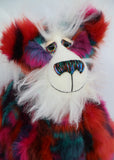 Delphine has large, beautifully hand painted glass eyes with eyelids, a wonderfully embroidered nose, sewn from individual threads to match her mohair and a rather reflective expression with a huge beaming smile. Her face, the fronts of here ears and the underside of his tail are a very long and fluffy white mohair