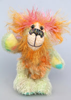 Diddy is made from several different fabrics, he's mostly a short, straight and sparse mohair that Barbara has hand dyed a gentle pale green. His tummy and the underside of his tail are a much longer, distressed mohair dyed a similar pale green with orange tipping, his face and the fronts of his ears are a long wispy mohair dyed a sunny orange and the top of his head is a long and wispy powder pink mohair. Diddy Gumdrops has hand dyed velvet paw pads 