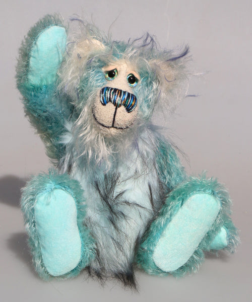 Dougal Dingle is a gentle, happy teddy bear, a beautifully blue one of a kind, hand-dyed mohair artist bear by Barbara-Ann Bears, he stands 10 inches/25 cm tall and is 8 inches/20 cm sitting.  Dougal Dingle is mainly made from a fluffy, sparse mohair that Barbara has hand dyed a beautiful sky blue with a faux fur tummy