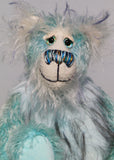 Dougal Dingle has beautiful hand painted eyes with eyelids, a nose embroidered from individual threads to complement his colouring and he has a huge, friendly smile. Dougal Dingle is mainly made from a fluffy, sparse mohair that Barbara has hand dyed a beautiful sky blue and his face the fronts of his ears and the underside of his tail are a long and fluffy white mohair with blue tipping. 