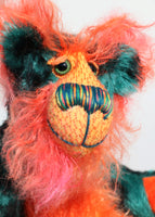 Douggie Dingle's face and the backs of his ears are a long, distressed, feathery mohair that Barbara has dyed a reddy-orange and which has a buttery yellow backcloth. He has beautiful, green glass eyes with hand coloured eyelids, a splendid nose embroidered from individual threads to compliment his colouring and he has a huge, friendly smile