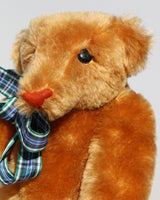 Droopy Nose has black eyes which catch the light so he often has a cheeky twinkle in his eye. Droopy Nose has a neat nose sewn in tan coloured thread so that it stands out from the mohair and he has a sweet smile. 