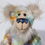 Elgar is made from a beautiful medium length mohair hand dyed in sky blue, emerald, lime, gold, amber and a greyish brown. His face, tummy, the underside of his tail and the fronts of his ears are a very long and luxuriously fluffy, pearly white mohair with a warm alabaster coloured backcloth. The velvet for Elgar's has paw pads was dyed with his mohair.  Elgar has beautiful, hand painted eyes with hand coloured eyelids, a nose embroidered from individual threads to match his colouring and a gentle smile