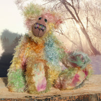 Emerson Ploom an elegant colourful, one of a kind, hand dyed mohair artist bear by Barbara-Ann Bears. He stands 16.5 inches (42 cm) tall and is 13 inches (33 cm) sitting and is made from long distressed mohair hand dyed in greens, blues, ambers, pinks, oranges, golds and lilac, the backcloth has been dyed a dull mauve