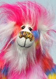 Fandango has beautiful hand painted glass eyes with eyelids, a wonderfully embroidered nose, sewn from individual threads to match his colouring and he has a huge beaming smile. He is mostly made from a multicoloured faux fur, it has patches of magenta, orange, yellow, blue and violet and his tummy and the top of his tail are a long faux fur in pink and white. His face and the fronts of his ears are a long white mohair and on top of his head head he has a plume of long and fluffy magenta faux fur