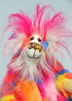 Fandango has beautiful hand painted glass eyes with eyelids, a wonderfully embroidered nose, sewn from individual threads to match his colouring and he has a huge beaming smile. He is mostly made from a multicoloured faux fur, it has patches of magenta, orange, yellow, blue and violet and his tummy and the top of his tail are a long faux fur in pink and white. His face and the fronts of his ears are a long white mohair and on top of his head head he has a plume of long and fluffy magenta faux fur