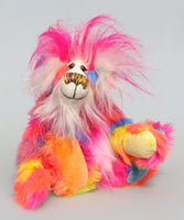 Fandango is a colourful, fun-loving and comical, one of a kind artist bear by Barbara-Ann Bears in luxurious mohair and rather wild faux fur. He stands 11.5 inches/29 cm tall and is 8 inches/20 cm sitting. Fandango is mostly made from a multicoloured faux fur, it has patches of magenta, orange, yellow, blue and violet