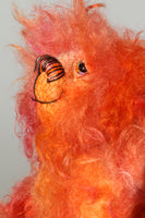 Flamin' Frizz has hand painted glass eyes with hand coloured eyelids. He has a carefully embroidered nose, sewn from individual threads to match the colouring of his mohair, and a warm beaming smile which gives him that puppy dog 'please pick me up and love me' expression